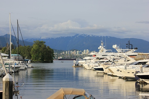 Vancouver, Canada – May 27, 2022: Parked yachts and boats in Coal Harbor in downtown Vancouver, British Columbia, Canada
