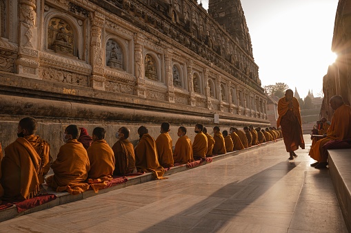 Bodhgaya, India – April 04, 2022: The Buddhist monks praying at Mahabodhi Temple in Bodh Gaya at sunrise