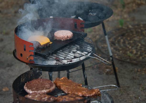 istock Burgers with cheese in preparation on the grill 1446182814