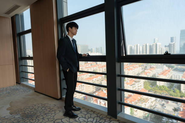 istock business man enjoying the scenery by the window 1446186376