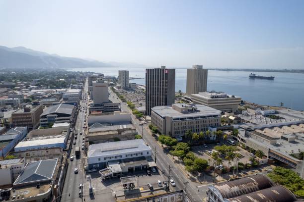 Aerial view of coastal buildings in downtown Kingston under the blue skyline Kingston, Jamaica – August 12, 2022: The aerial view of coastal buildings in downtown Kingston under the blue skyline kingston harbour stock pictures, royalty-free photos & images