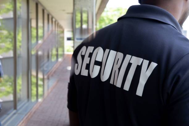 istock Security person standing in the balcony of a building 1446189146