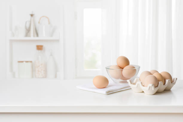 istock Brown chicken eggs in carton box on kitchen table interior 1446191077