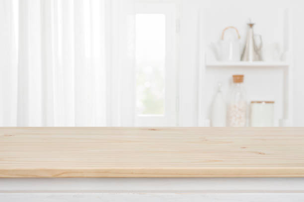 istock Wood table on blur kitchen window background for product montage 1446191080