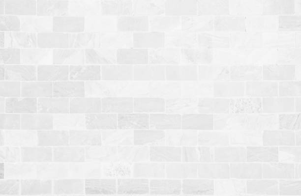White grunge brick wall texture background for stone tile block painted in grey light color wallpaper modern interior and exterior and room backdrop design. Simple seamless pattern grid for backdrop.