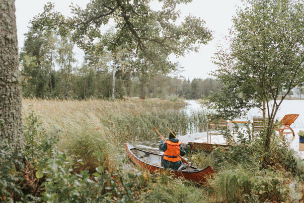 Photo series of young Nordic woman living in the countryside, going for a canoe ride at her summer cottage.