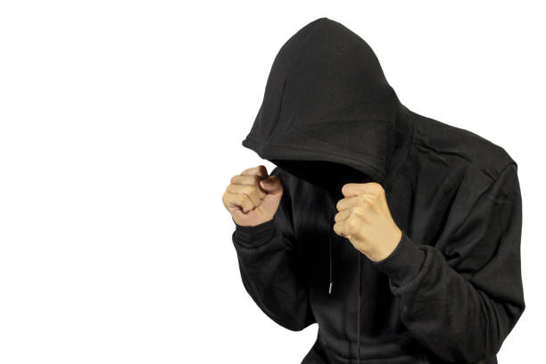 istock man wearing black hoodie on white background, hacker, data thieves,ready to fight 1446195232