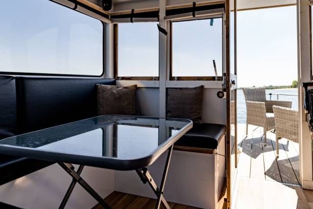 istock Foldable table and a couch inside a yacht and chair outside under the sunlight 1446195960