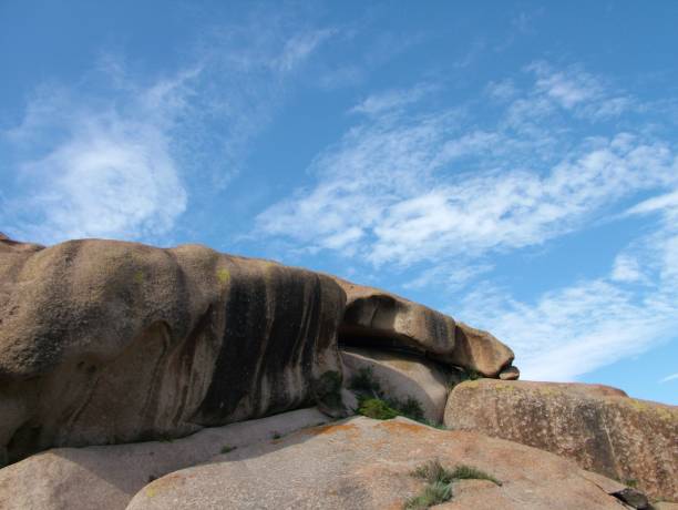istock Rock formations against a blue cloudy sky under the sunlight 1446196966