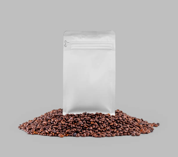 istock Mockup of white doy pack, zip gusset packaging on coffee beans, close-up, front view, isolated on background. 1446198003