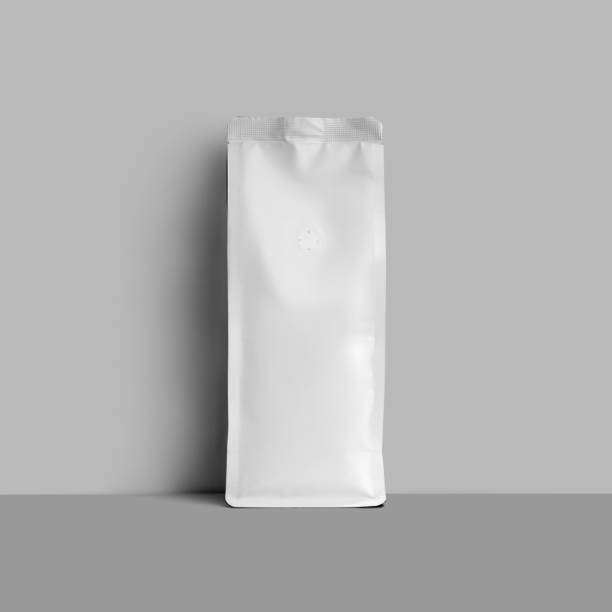 istock Mockup of white packaging for coffee beans, empty stable coffee pouch isolated on wall background. 1446198293