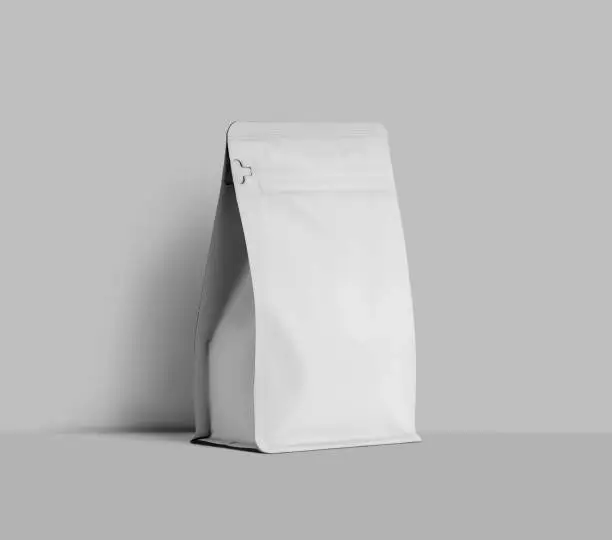 Mockup of a white doy pack for coffee beans, zip packaging near the wall, for design, pattern, branding. Tea pouch template, pack with product, isolated on background.