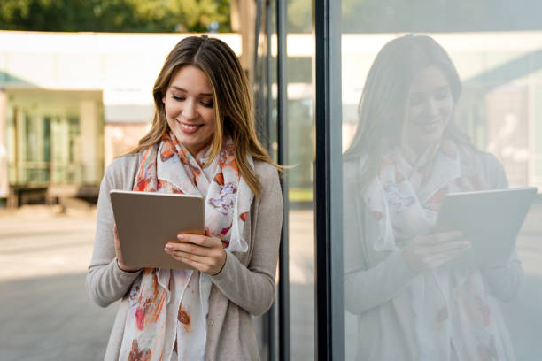 istock Beautiful young woman using digital tablet and smiling 1446200844