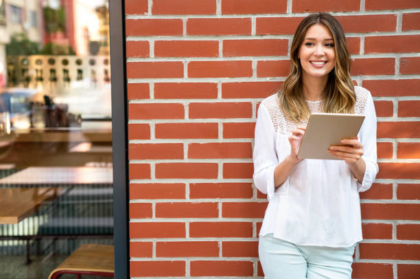 istock Youth and technology. Attractive young business woman using tablet computer outdoors. 1446200846