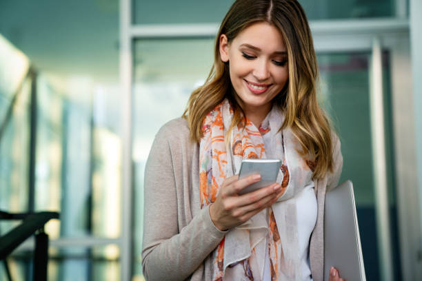 istock Beautiful business woman using mobile phone outdoors. People communication technology concept. 1446200891
