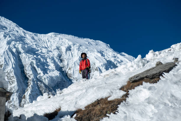 Snow-capped mountains and a tourist in a sunny day