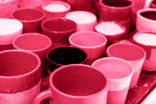 Set of magenta toned cups closeup in street store