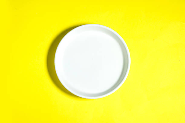 istock Modern oriental ceramic plate View from above isolated on yellow background with clipping path 1446207475
