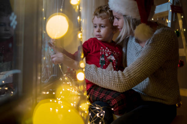istock Young mother drawing with her boy on the window 1446211087