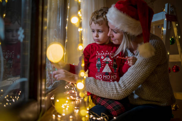 istock Young mother drawing with her boy on the window 1446211101