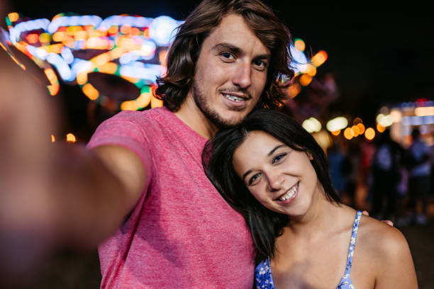 istock Young Couple Taking Selfies In An Amusement Park 1446213834