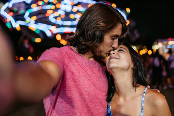 istock Young Couple Taking Selfies In An Amusement Park 1446213890