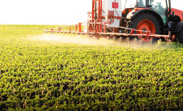 istock Tractor spraying soybean crops field 1446213988