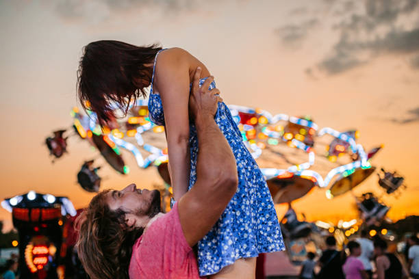 istock Young Couple Having Fun In An Amusement Park 1446214207