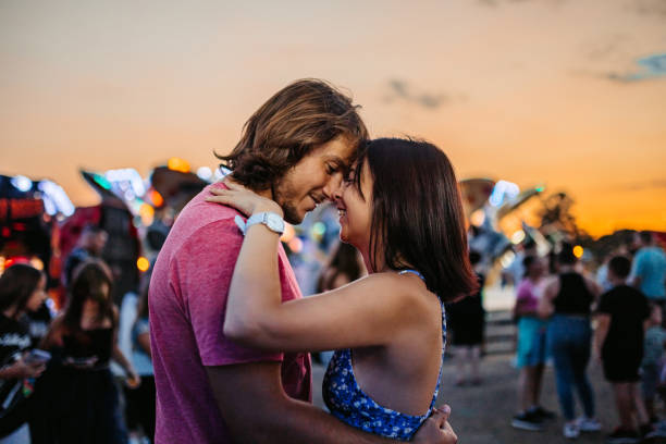 istock Young Couple Embracing In An Amusement Park 1446215105