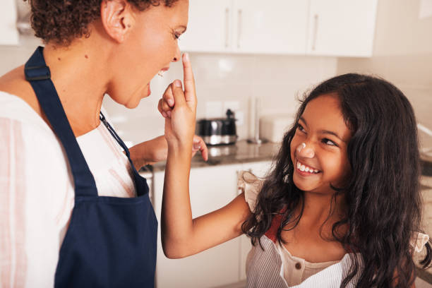 istock Granddaughter and grandmother having fun together in the kitchen while baking cupcakes 1446215182