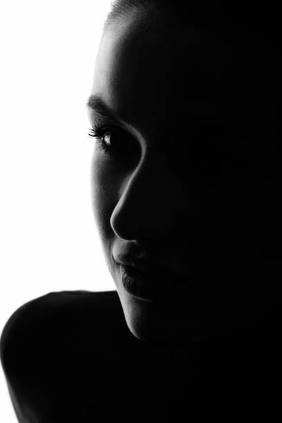 istock Part beautiful woman face silhouette covered in shadow 1446215550