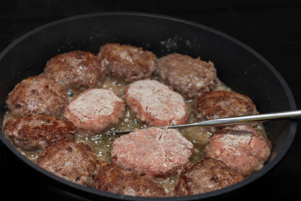a frying pan full of delicious cutlets made of meat, indoor closeup