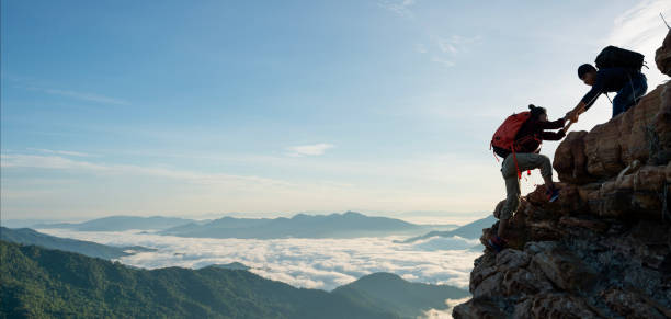 istock Asian hiking help each other on mountains 1446216707