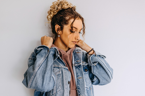 Portrait of a young adult woman against a white background