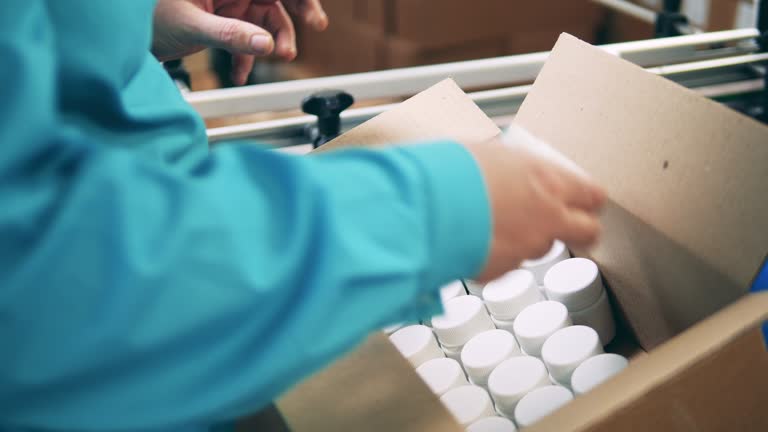 Plastic tubs are getting relocated into a carton box