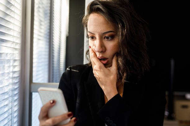 istock Young woman looking shocked after reading a text message 1446217240