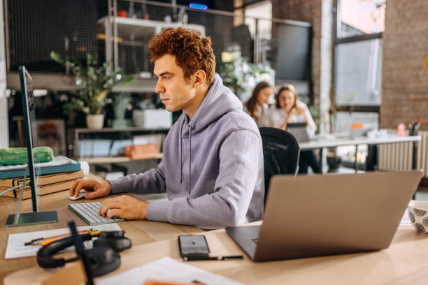 istock Casually clothed man working on a PC in the office 1446219753