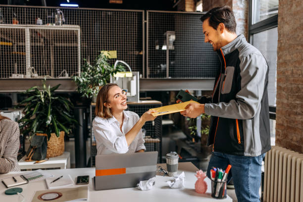 istock Young woman getting delivery while working in the office 1446220352