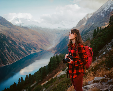 Young Caucasian woman hiking  in Austrian Alps  in autumn