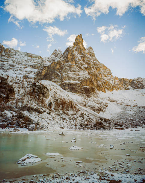 Scenic view of snow-covered lake in Dolomites in winter at sunset shot on film