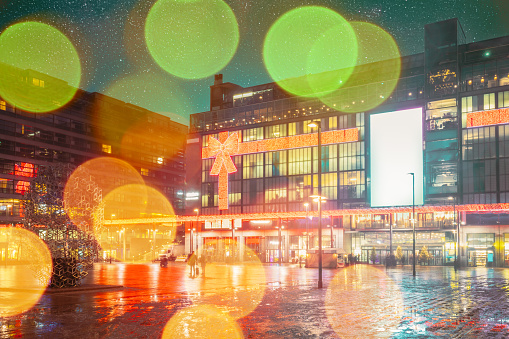 Helsinki, Finland. Effect Bokeh View On Shopping Centre In Night Evening Illumination. Boke Blured View