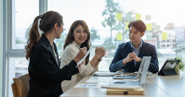 istock Young asian business group with the creative work, talk and exchange ideas shared at the meeting 1446225049