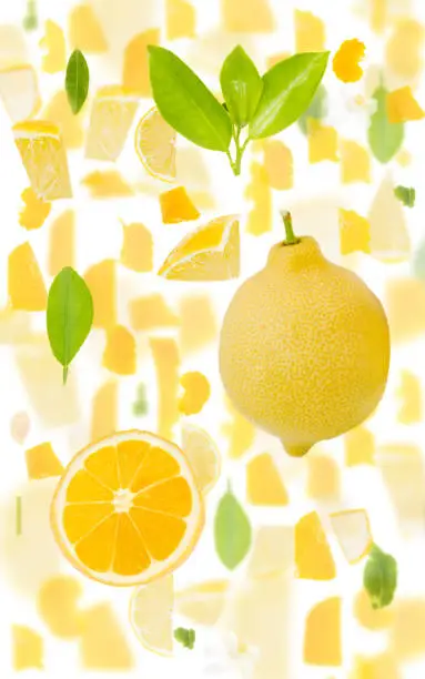Abstract background made of Lemon fruit pieces, slices and leaves isolated on white.