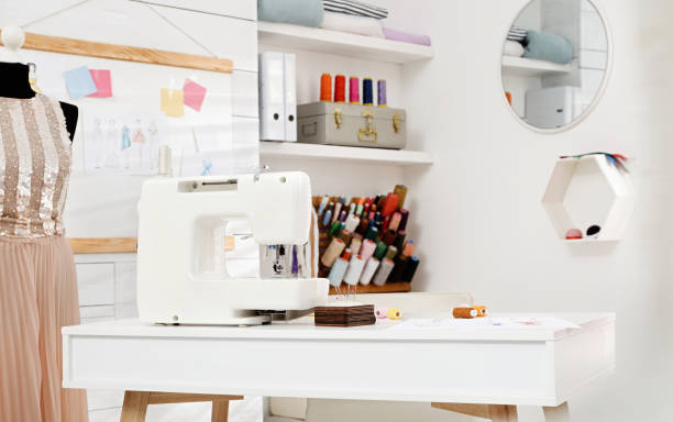 istock Dressmaking workshop interior with modern sewing machine, mannequin and accessories 1446225553