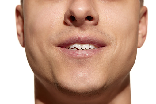 Mouth and teeth. Cropped face of young man with well-kept skin isolated on white studio background. Concept of dental health, self-care, medicine and dentistry, cosmetics.