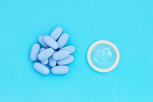 istock Condom with PrEP ( Pre-Exposure Prophylaxis) blue pills used to prevent HIV 1446229207