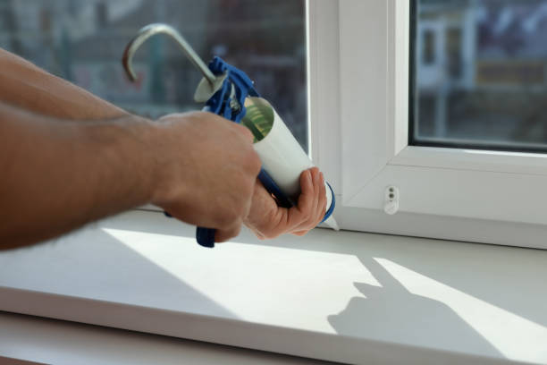 istock Man sealing window with caulk indoors, closeup 1446234227
