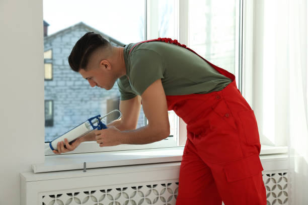 istock Construction worker sealing window with caulk indoors 1446234228
