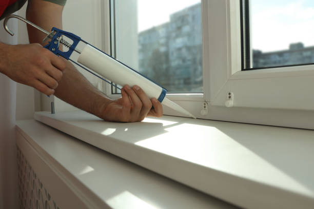 istock Man sealing window with caulk indoors, closeup 1446234231