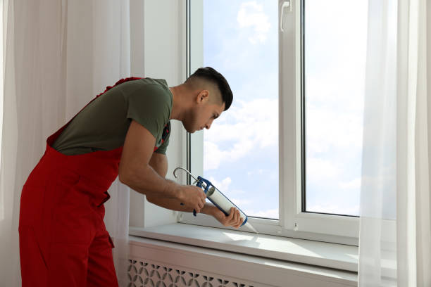 istock Construction worker sealing window with caulk indoors 1446234271